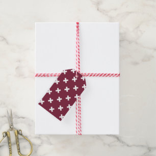 White cross stitches on mulberry gift tags
