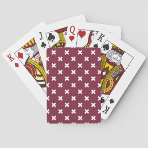 White cross stitches on mulberry playing cards