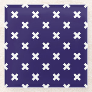 White cross stitches on navy blue glass coaster
