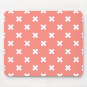 White cross stitches on peach mouse pad