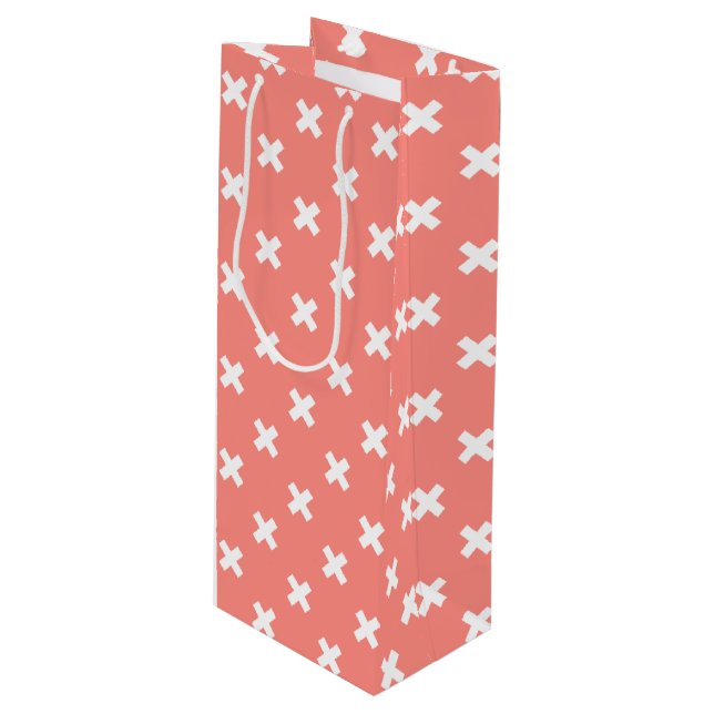 White cross stitches on peach wine gift bag (Front Angled)
