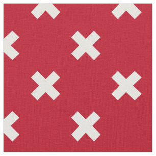 White cross stitches on red fabric