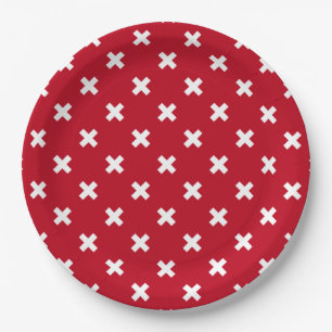 White cross stitches on red paper plate