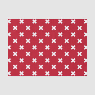 White cross stitches on red tissue paper