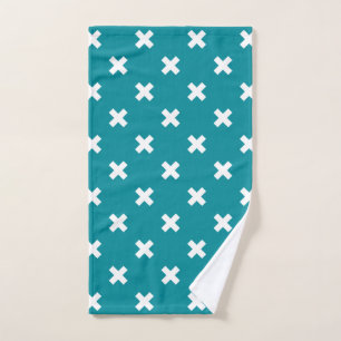 White cross stitches on teal hand towel