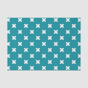 White cross stitches on teal tissue paper