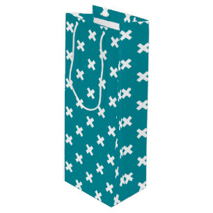 White cross stitches on teal wine gift bag