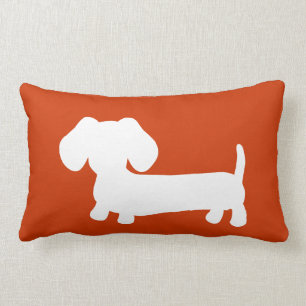 White Dachshund with on orange Lumbar Cushion