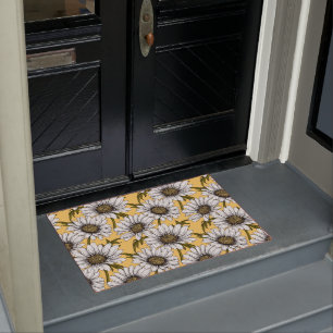 White daisies, wild flowers on yellow doormat