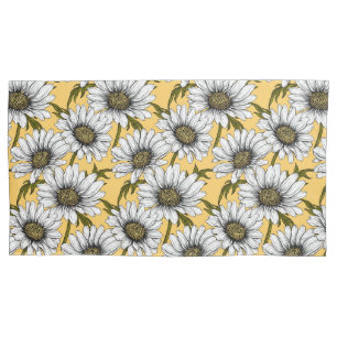 White daisies, wild flowers on yellow pillowcase