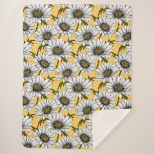 White daisies, wild flowers on yellow sherpa blanket