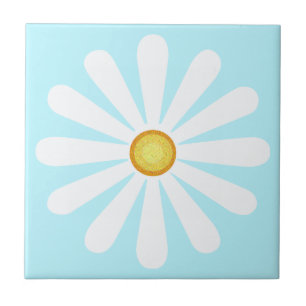White daisy, yellow centre, on pale cyan tile