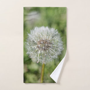 White dandelion flower on green grass hand towel