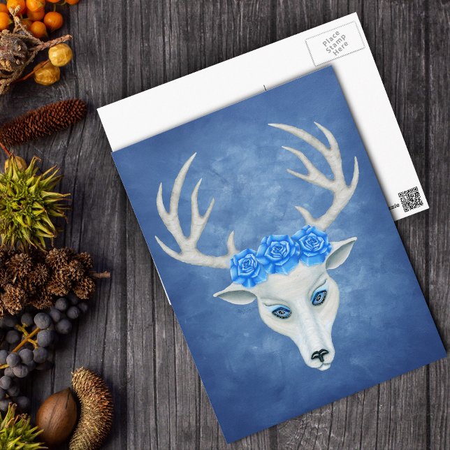 White Deer Head With Antlers Big Blue Roses Postcard (Surreal white fantasy deer head with antlers and big blue roses on blue postcard.)