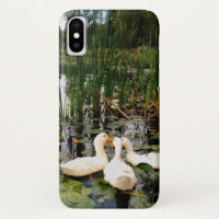 White ducks, lily pads, cattails, lake shore