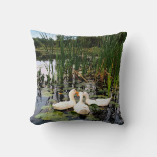 White ducks, lily pads, cattails, lake shore cushion