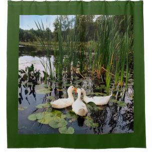 White ducks, lily pads, cattails, lake shore shower curtain