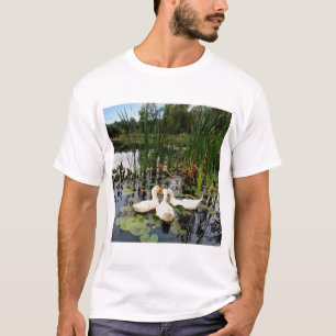 White ducks, lily pads, cattails, lake shore T-Shirt
