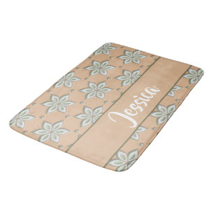 White engraved flowers on tan bath mat