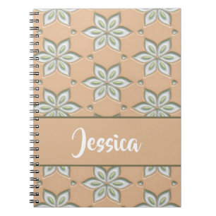 White engraved flowers on tan notebook