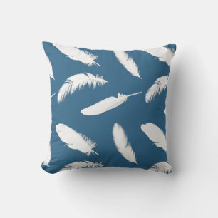 White feather print on denim blue cushion