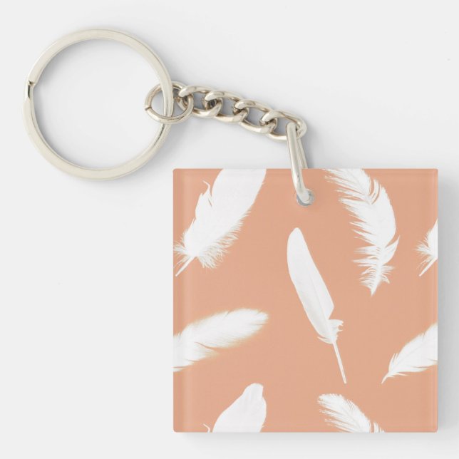 White feather print on soft peach key ring (Front)