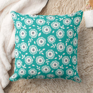 White floral pattern on turquoise background cushion