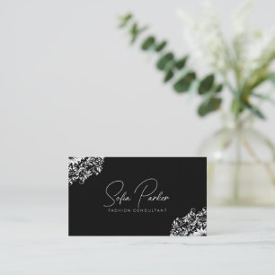 White floral swirl on black business card