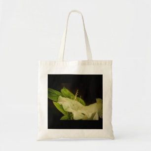 White flower in the darkness tote bag
