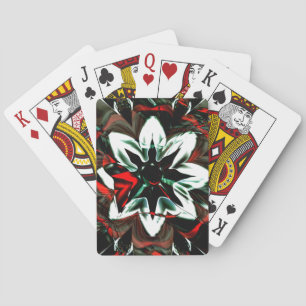 White flower surrounded by dark tones and glossy playing cards