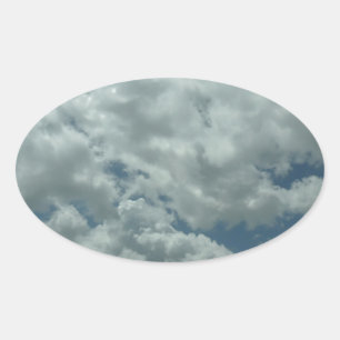 White, fluffy clouds in blue sky oval sticker
