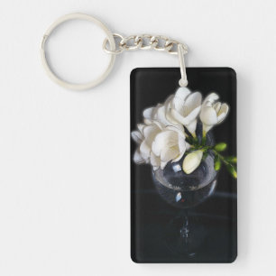 white freesia in a glass key ring