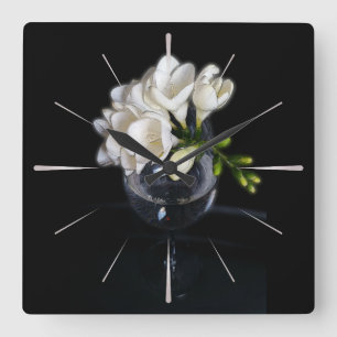 white freesia in a glass square wall clock