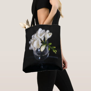 white freesia in a glass tote bag