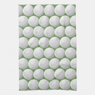 white golf balls on green tea towel