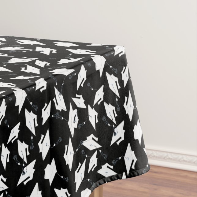 White Graduation Caps Tossed in the Air on Black Tablecloth (In Situ)