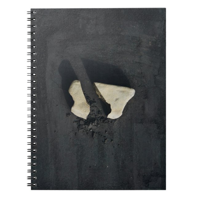 White heart shaped on black surface notebook (Front)