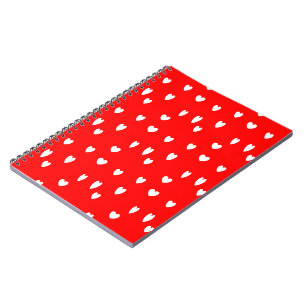 White hearts pattern on red notebook