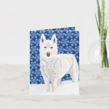 White Husky against Snow Flakes and dark blue sky 