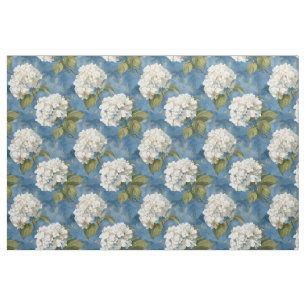 White hydrangea blossoms on blue fabric