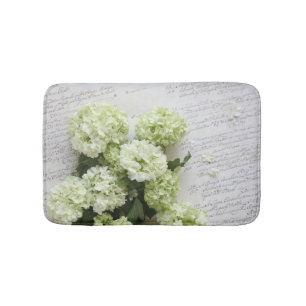 White hydrangeas with script writing bath mat
