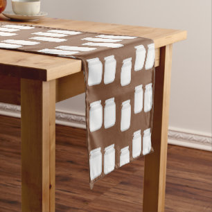White jars on brown short table runner
