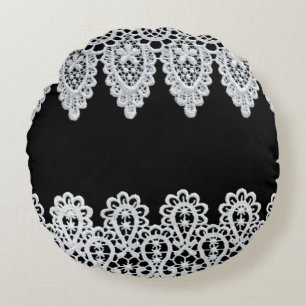 White lace forms a delicate border against black round cushion
