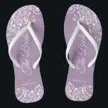 White Lace on Dusty Purple The Bride Wedding Thongs<br><div class="desc">Dance the night away with these beautiful wedding flip flops. Designed for the bride, they feature a simple yet elegant design with fancy script lettering on a dusty purple, lavender, or lilac coloured background and white lace curls and swirls. Beautiful way to stay fancy and appropriate while giving your feet...</div>