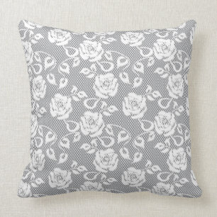 White lace pattern on grey background cushion