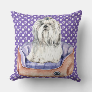 WHITE MALTESE DOG SITTING IN PURPLE DOG BED CUSHION