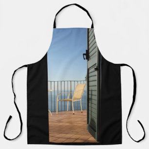 White metal armchair beside fence in the morning apron