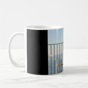 White metal armchair beside fence in the morning coffee mug