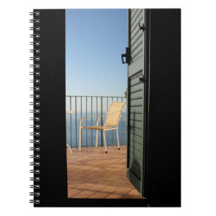 White metal armchair beside fence in the morning notebook