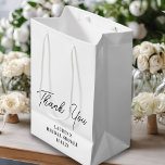 White Minimalist Bridal Shower Thank You Medium Gift Bag<br><div class="desc">Make their day extra special with this charming White Minimalist Bridal Shower Thank You Gift Bag,  personalised with the bride's name and wedding date. This elegant bag is the perfect way to show your gratitude for being a part of the celebration!</div>